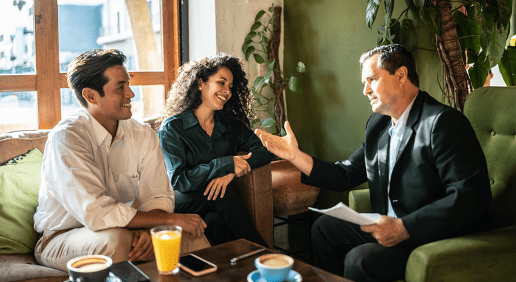 Photo depicting a Tallahassee real estate agent and a couple discussing real estate in Tallahassee, Florida.