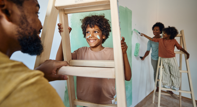 A family that is new homebuyers is painting the interior of a new home purchased in Tallahassee Florida real estate.